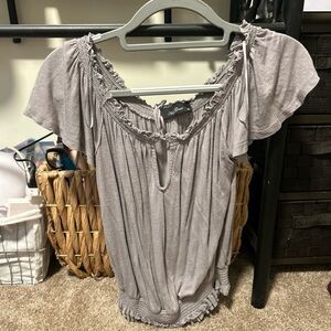 Gray flowy shirt that gets tight at the bottom